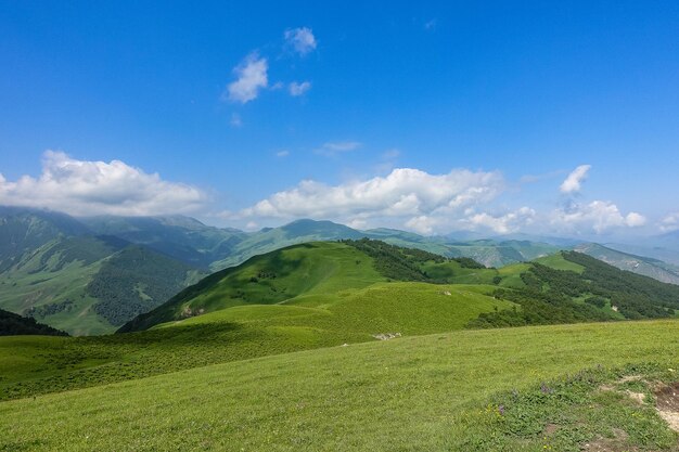 The landscape of the green Aktoprak pass in the Caucasus the road and the mountains under gray clouds KabardinoBalkaria Russia