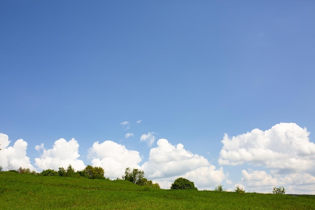 The landscape is similar to Windows XP Blue sky with clouds and green field