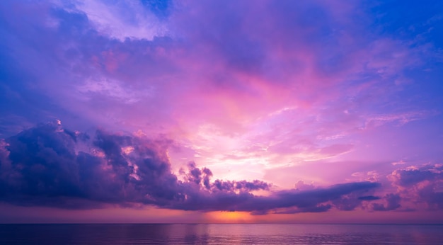 Landscape Long exposure of majestic clouds in the sky sunset or sunrise over sea with reflection in the tropical sea Beautiful landscape scenery Amazing colorful light of nature Landscape