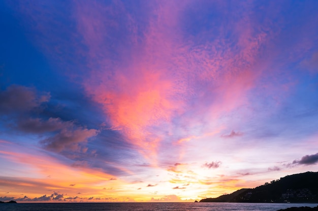 Landscape Long exposure of majestic clouds in the sky sunset or sunrise over sea with reflection in the tropical sea Beautiful landscape scenery Amazing colorful light of nature Landscape