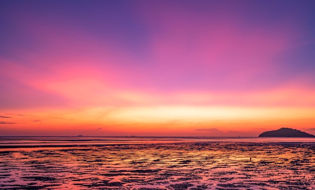 Landscape Long exposure of majestic clouds in the sky sunset or sunrise over sea with reflection in the tropical sea Beautiful landscape scenery Amazing colorful light of nature Landscape