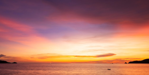 Landscape Long exposure of majestic clouds in the sky sunset or sunrise over sea with reflection in the tropical sea Beautiful seascape scenery Amazing light of nature sunset