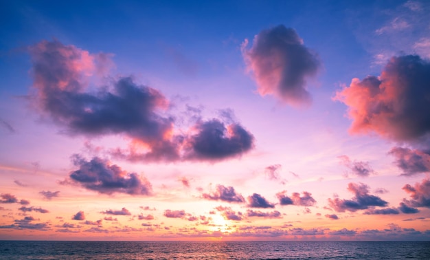 Landscape Long exposure of majestic clouds in the sky sunset or sunrise over sea with reflection in the tropical seaBeautiful cloudscape sceneryAmazing light of nature Landscape nature background