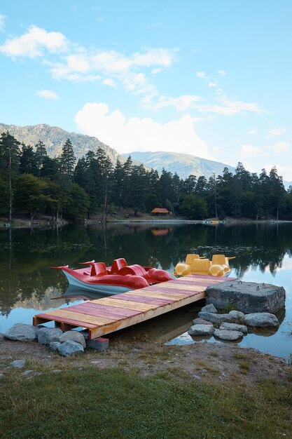 Landscape mountain lake catamaran on the lake shore water bike water surface