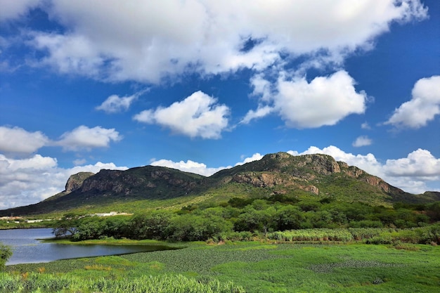 Landscape of a mountain range with mountains lake and vegetation on a beautiful day with blue sky