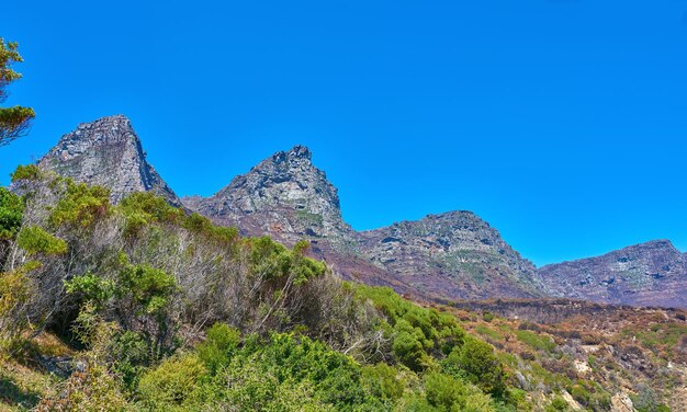 Landscape mountain view and blue sky of Twelve Apostles with copy space in remote countryside hiking forest Scenery of famous landmark in an environmental nature reserve in Cape Town South Africa