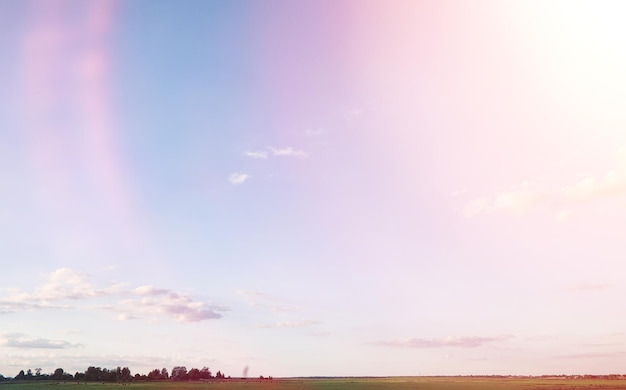 Landscape outside the city. Grassy field and blue sky. Sunset over the village field