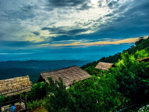 Landscape panorama blue sky white cloudy hut house village tree environment forest hill mountain natural beautiful for travel tourism trip asia thailand holiday vacation