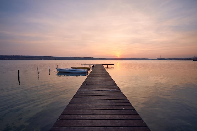 Landscape photo of a jetty and boats on lake at sunset in Varna Bulgaria