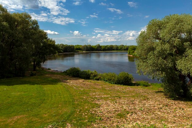 Landscape on the riverbank with sky reflection