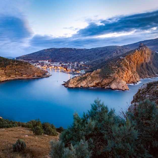 Landscape sea mountains city at dawn balaklava bay