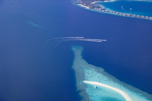 Landscape seascape aerial view maldives luxury resort villas atoll sandbank island and jet skies