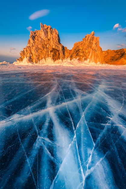 Landscape of Shamanka rock at sunset with natural breaking ice on Lake Baikal, Siberia, Russia