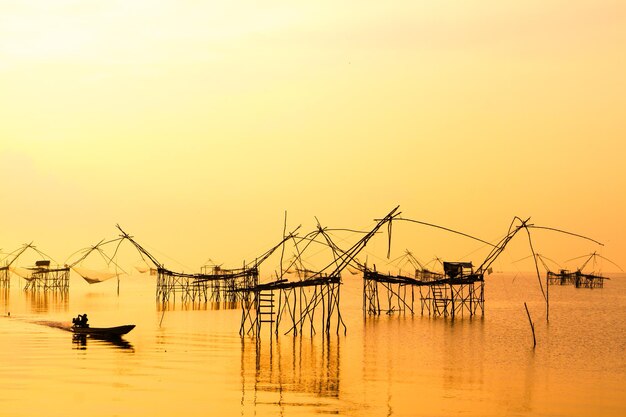 Landscape of square dip net or YoThai languagemade of bamboo in morning at Ban Pak Pra Talay Noi Lake Phatthalung Thailand