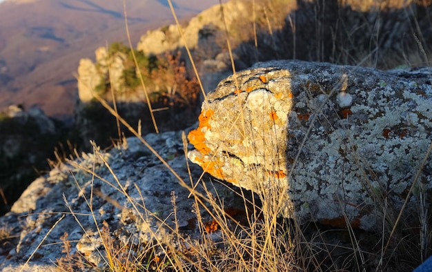 Landscape of the sun rising in the mountains Orange reflexes from the sun on the rocks