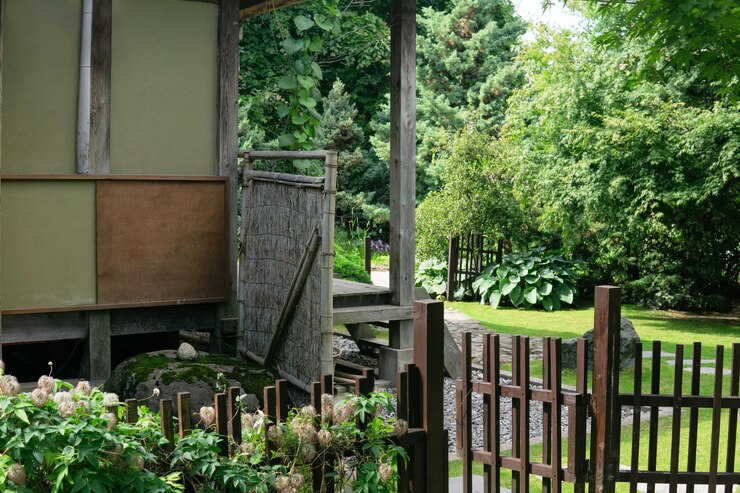 landscape of a traditional Japanese garden with plants paths and a fragment of a pavilion