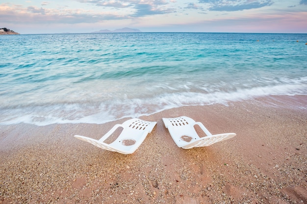 Landscape of two beachchairs near the sea