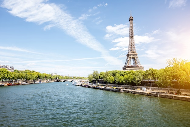 Landscape view on the Eiffel tower and Seine river during the sunny day in Paris