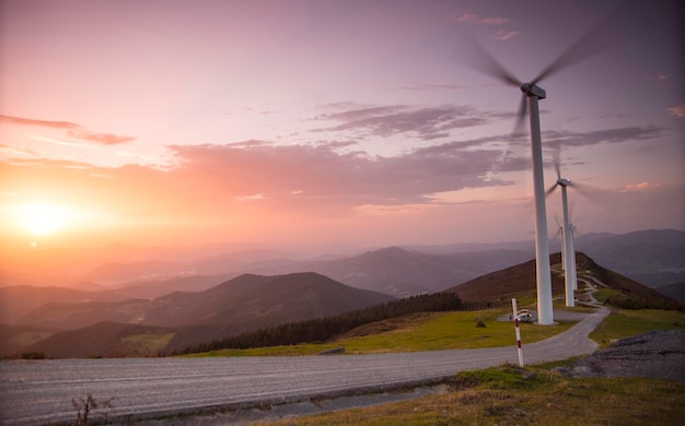 landscape view of eolic generators in a hilltop at sunset