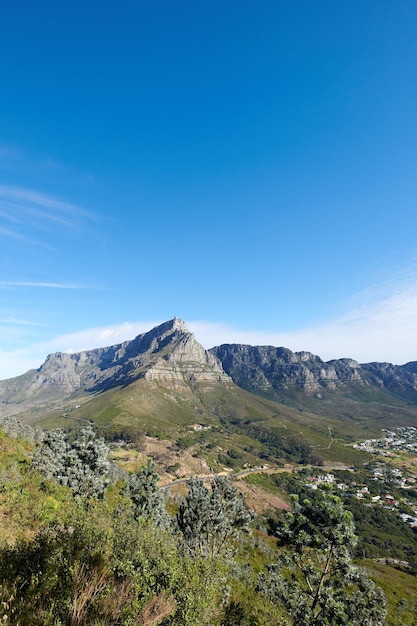 Landscape view of mountains background from a lush green botanical garden and national park Table Mountain in Cape Town South Africa with blue sky and copy space while discovering peace in nature