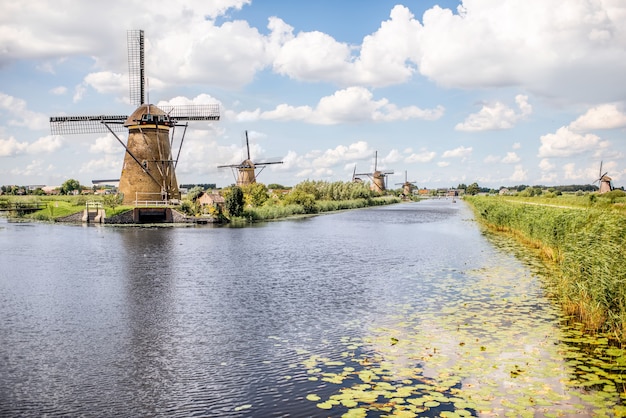 Landscape view on the old windmills during the sunny weather in Kinderdijk village, Netherlands