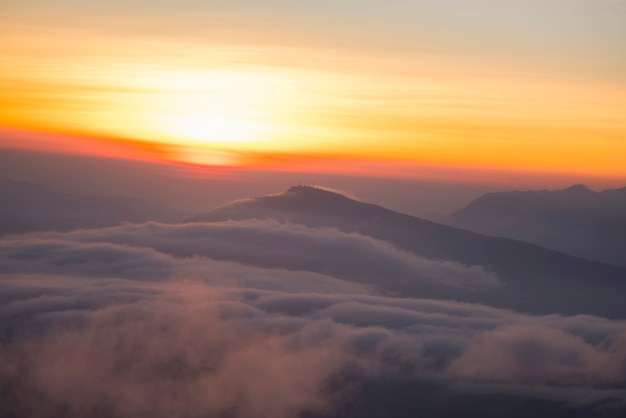 Landscape view point looking for foggy mist cover forest mountain and beautiful sunrise colorful sky