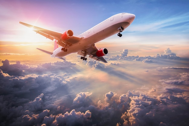 Landscape with aircraft is flying above clouds in the blue sky