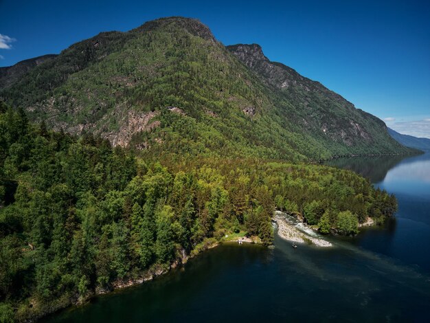 Landscape with boats in the water lake with views of the mountains. Teletskoye Lake Altai in Siberia.