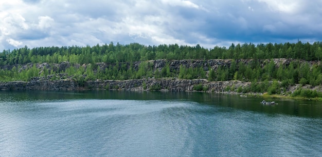 landscape with a clear lake on the site of an old stone quarry