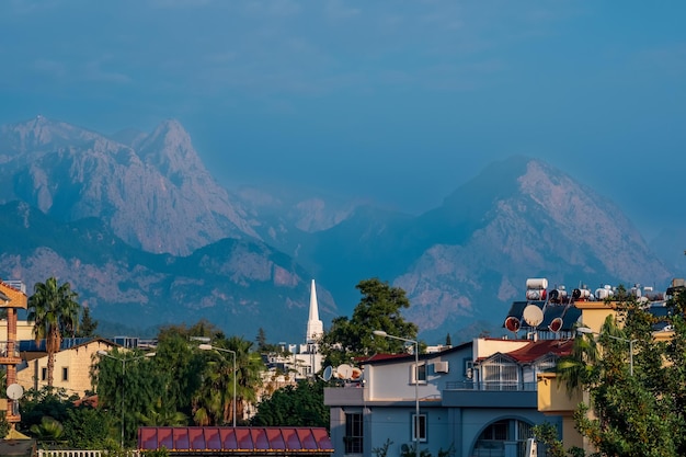 Landscape with distant blue mountains behind city rooftops Kemer Antalya Turkey