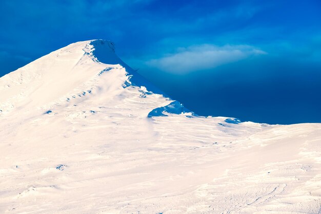 Landscape with mountain peak in snow at sunset