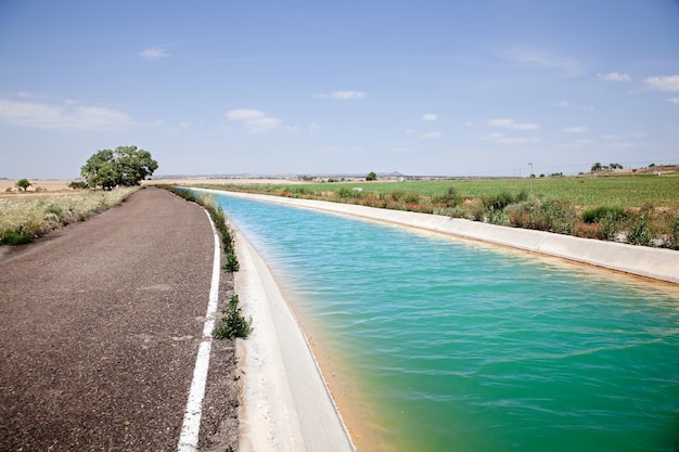 Пейзаж с дорогой и водным каналом