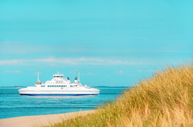 Landscape with a single boat navigating on North Sea on a sunny day