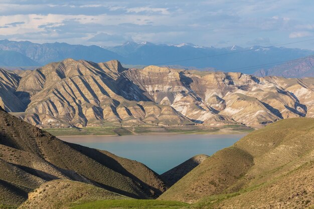 landscape with Toktogul lake under colourful barren mountain range Tien Shan range Kyrgyzstan