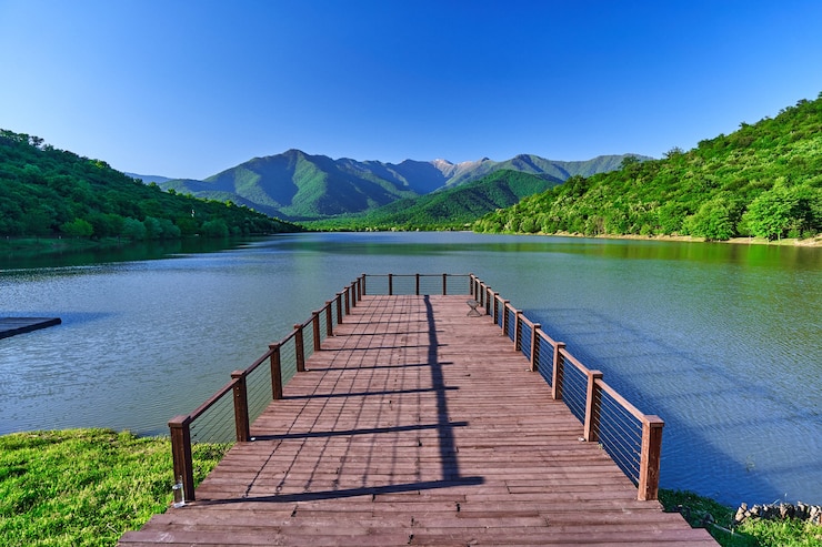 Photo 아름다운 호수와 산의 전경을 조망할 수 있는 목조 부두의 풍경. 자연의 고요하고 조용한 평화로운 분위기