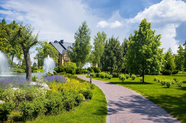 Landscaping in the garden The path in the gardenBeautiful backyard landscape designSome flowers and nicely trimmed bushes on the leveled front yardLandscape formal