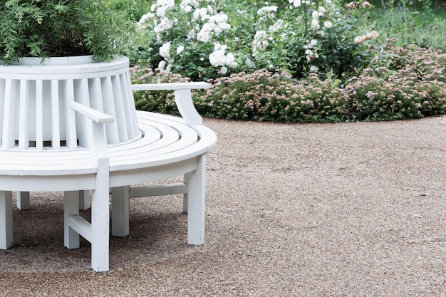 Photo landscaping of the local area with white benches gravel paths and flower beds