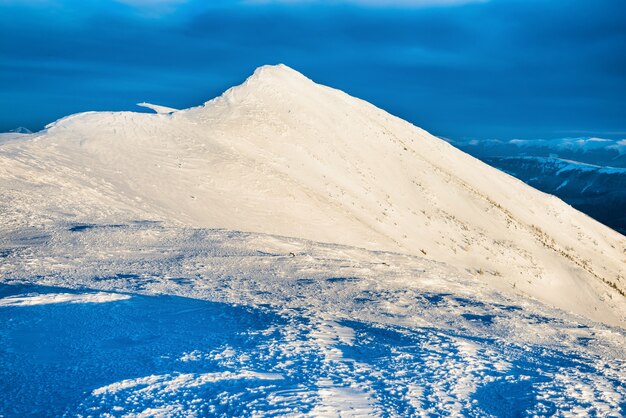 Landschap met bergtop in sneeuw bij zonsondergang