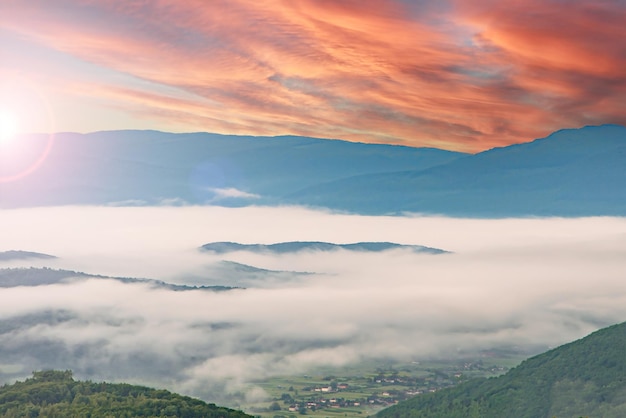 Landschapsmist ochtendmist in de bergen dikke mist over de bergen in de stralen van de zon een mooie lucht