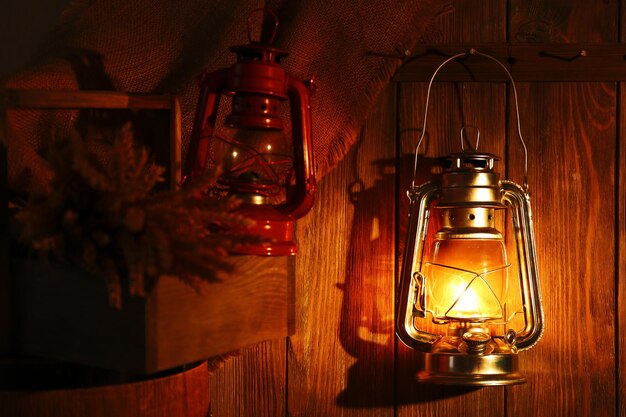 Lantern hanging on hook on wooden wall