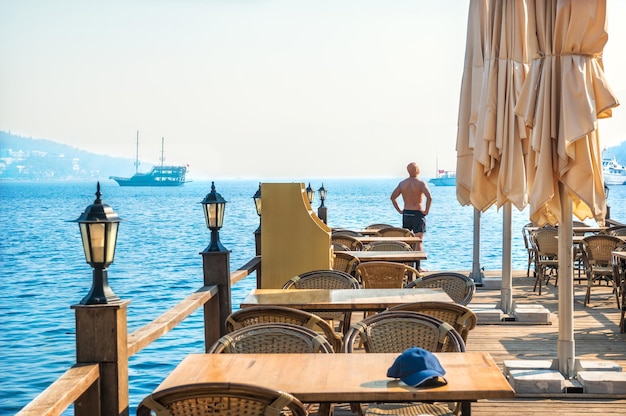 Lanterns and tables on the pier by the sea and tourist Marmaris Turkey