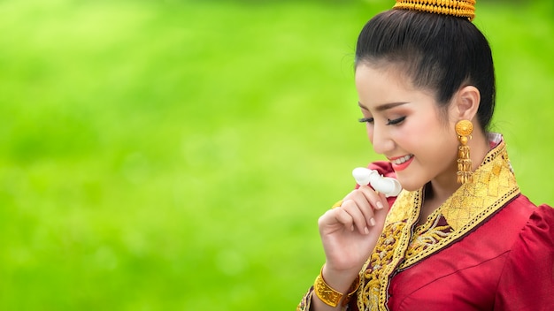 Lao girl face in traditional dress with Laos national flower, Champa flower.