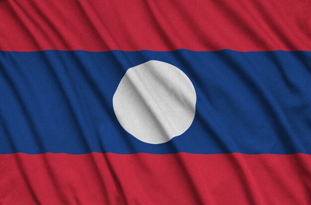 Laos flag  is depicted on a sports cloth fabric with many folds.