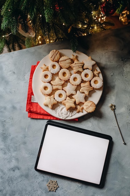 laptop on the background of a Christmas tree, online work on holidays, mockup device