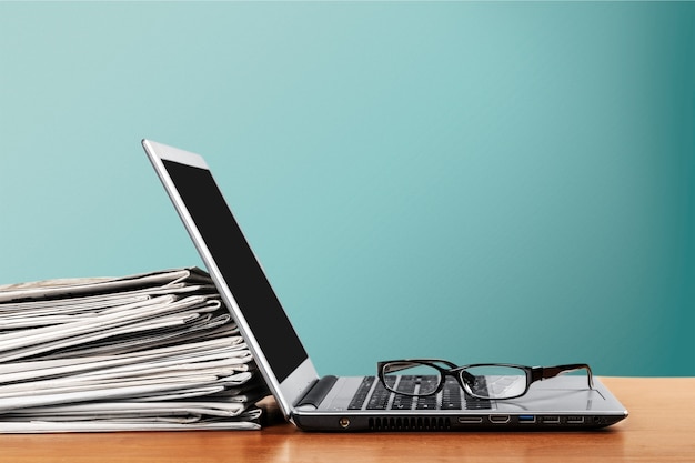 Laptop and black glasses  on   background.