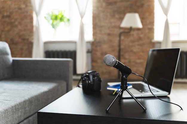 Laptop camera microphone and notebook on a journalist's work desk