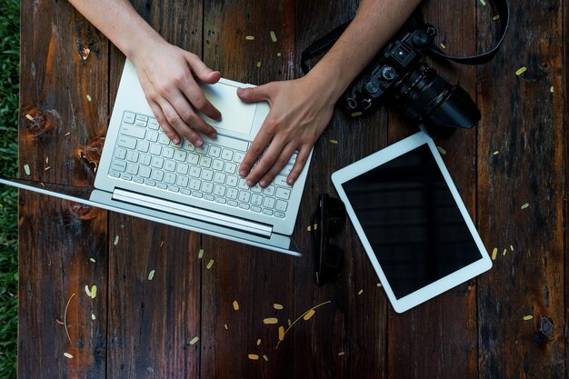 Laptop camera on wooden background Flat lay of working place of freelancer or individual entrepreneur