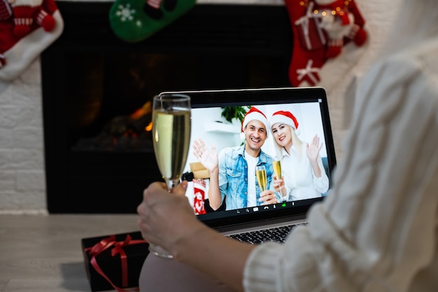 Laptop on the christmas table. Video call with the family in times of coronavirus.