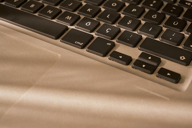 Laptop closeup on a wooden table with daylight.