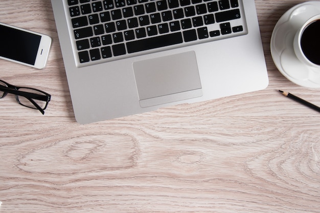 Laptop and coffee cup on wood table